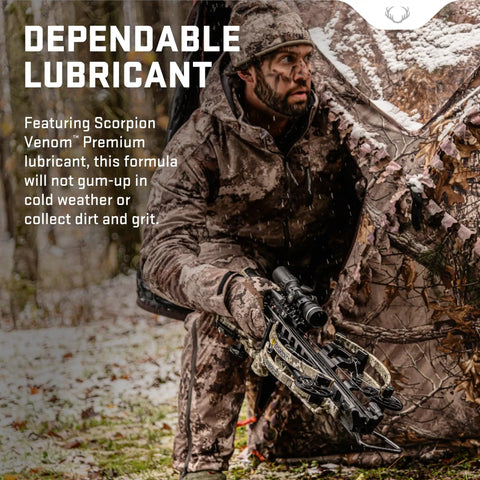 Hunter using a crossbow with Premium Crossbow Lubricant With Foam Applicator in a snowy woodland setting.