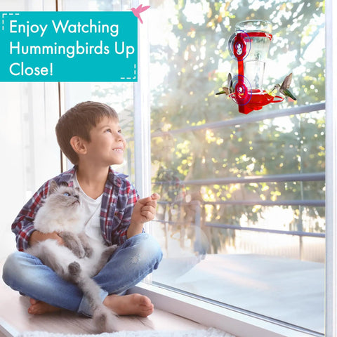 Window Hummingbird Feeder With Side Ports For Clear Viewing Big 20 Oz Nectar Capacity Durable Plastic Easy Clean And Refill Strong Suction Cups Outdoor Window Bird Feeder For Kids And Pets with child and pet watching hummingbirds.