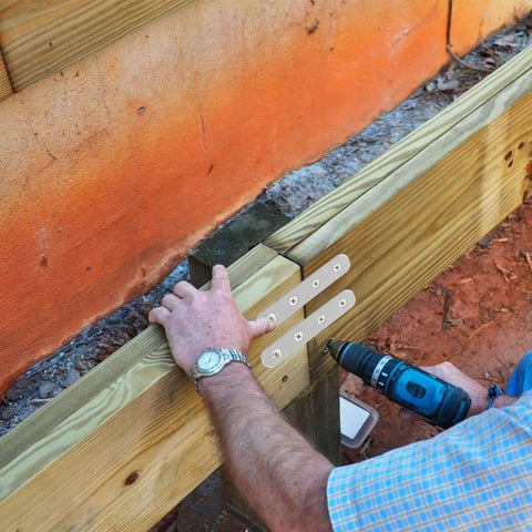 Installation of 80 Piece Stainless Steel Flat Plate Brackets on wood, securing joints for stability and flush mounting.