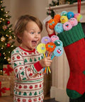 Child holding Fluffy Pom Pom Pens 24 Pack Cute Plush Kawaii Novelty Pens for Kids and Adults Soft Face Fun Pens for Desk School Office Supplies.