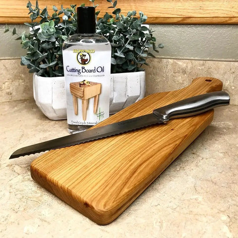 Butcher Block Oil And Conditioner Cutting Boards Food Grade Rehydrates Wood 12 Oz with bread knife on wooden board