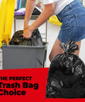Person using Beefy 55 Gallon Contractor Trash Bags 2 Mil Thick Heavy Duty Drum Liners For Industrial And Commercial Use in kitchen bin.