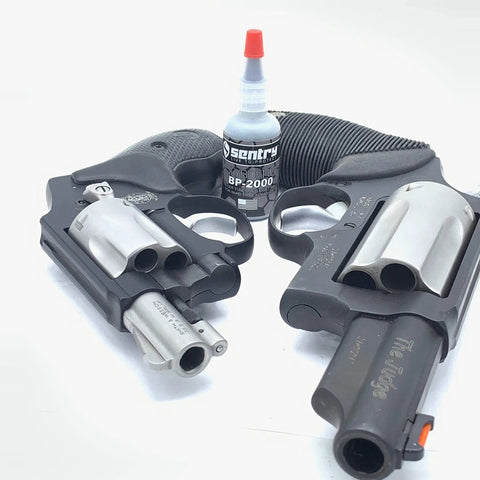 BP2000 Dry Powder Lubricant For Triggers Bores Bolts And Slides 0.1 oz bottle next to revolvers, reduces friction