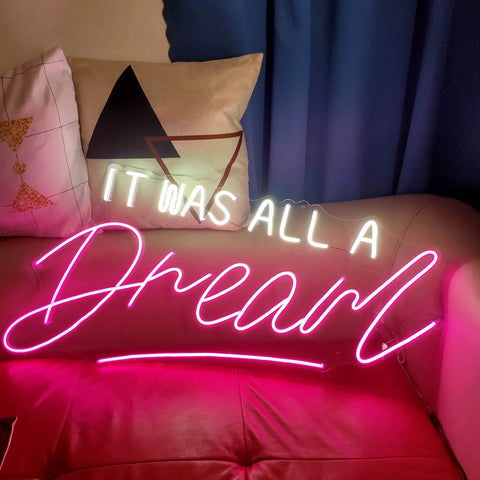 It Was All a Dream Neon Sign For Bedroom LED Wall Decor Light With Dimmer Handmade For A Cozy Mood Vibe Ideal Night Light Party Decor Accent Wall Art At Home, white and pink neon on couch.