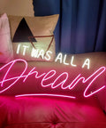 "It Was All A Dream Neon Sign For Bedroom Wall Decor LED Neon Light With Dimmer Handmade Wall Art on sofa with pillows."