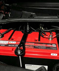 Badass 18-8 Stainless Steel J Hook Battery Hold Down Bolts Kit securing a red battery in an engine bay with trimmable rods.