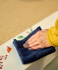 Hand wiping surface with cloth for Dry Erase Whiteboard Cleaner Spray 22oz Eliminates Ghosting And Streaks Easy Wipe No Hassle