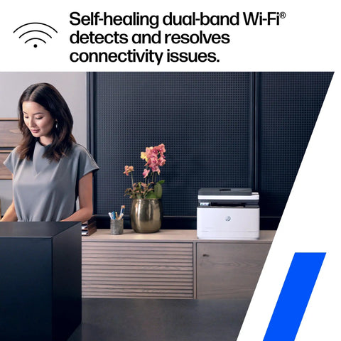 All In One Wireless Black And White Laser Printer With Scanner Copier And Fax For Small Office Teams Fast Two Sided Printing Auto Document Feeder Easy Scan And Copy Ideal For Up To Seven Users shown on a wooden desk in an office setting with a self-healing dual-band Wi-Fi feature advertisement.