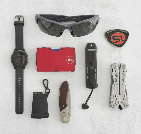 Everyday carry gear including Wedge XT 500 Lumen EDC Flashlight With 1900 Candela Beam displayed on a surface.