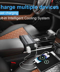 Keep Your Gear Juiced While You Cruise Down The Pavement With This Badass 300W Power Inverter Car Adapter charging multiple devices in a car.