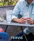 Two people at a table with Washington Commanders 24oz Double Wall Insulated Tumbler Cup Keeps Drinks Cold Or Hot All Day BPA Free