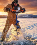 Person using Gas Powered 52Cc 2 In 1 Ice Auger And Earth Auger Kit with 10 Inch Ice Bit on frozen lake at sunset.