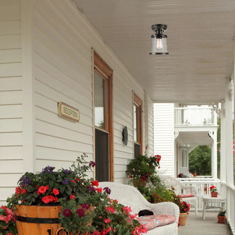 Charlie One Light Outdoor Indoor Semi Flush Mount Ceiling Light In Oil Rubbed Bronze With Clear Seeded Glass Shade Weather Resistant Bulb Not Included installed on a porch ceiling