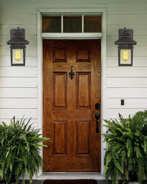 Outdoor Wall Light Lanterns, Black Cast Aluminum Exterior Fixtures With Seeded Glass beside a wooden door on porch