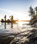 Boaters on a lake near rocks using EPA And CARB Certified 3 Gallon Portable Marine Boat Fuel Tank With Automotive Grade Multi Layer Construction Automatic Vacuum Valve For Consistent Fuel Flow