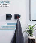 Bathroom view showcasing two matte black square towel hooks with a towel hanging. Six Pack Square Towel Hooks In Matte Black.