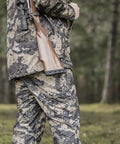 Hunter carrying rifle with AirTech Precision-Fit Recoil Pad for Christensen Arms, Marlin, and Remington rifles in forest.