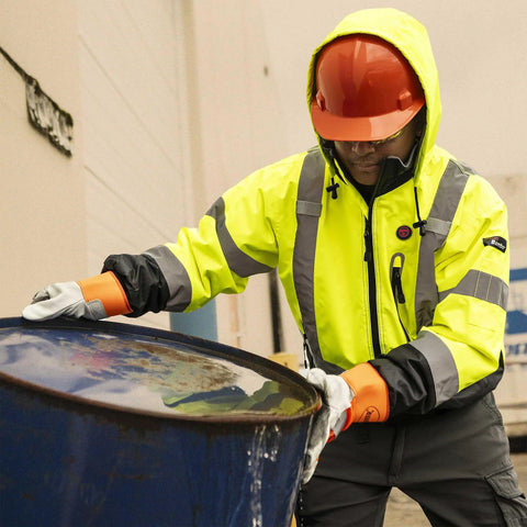 Worker in Hi Vis Heated Safety Bomber Jacket With Reflective Tape And Detachable Hood Waterproof Winter Rain Gear For Men Class 3 USB Powered Nano Heating With Four Settings Warms Up To Eighteen Hours Machine Washable Workwear Ready handling barrel outdoors