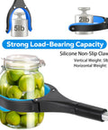 Blue 32-inch foldable grabber tool with silicone jaws gripping a glass jar of green apples