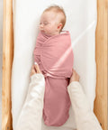 Parent holding baby in Cozy Baby Swaddle Blanket Set Three Pack 100 Percent Cotton Newborn Wraps For 0 To 3 Months in mauve color