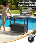 Man pushing 80 Quart Rolling Ice Chest With Built In Top Prep Table And Four Wheels Party Patio Cooler Cart next to pool