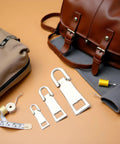 3 Pack Silver Zipper Pull Replacements Set For Luggage, Backpack, Jacket And Coat Repairs with sewing notions displayed