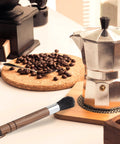 Front view of Takavu coffee grinder cleaning brush with black boar bristles on wooden handle.