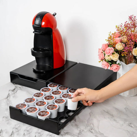 Hand accessing compact black drawer for 20 coffee pods under a brewer, focus keyword: Stash Your Coffee With This Space Saving K Cup Pod Drawer Organizer For 20 Pods Fits Nespresso Dolce Gusto And K Cup Capsules Compact Black Storage Drawer That Stacks On Top Of Your Brewer