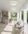 Covered porch with Crystal Ceiling Light With Memory Function Dimmable LED Chandelier installed above wicker furniture, exterior view.