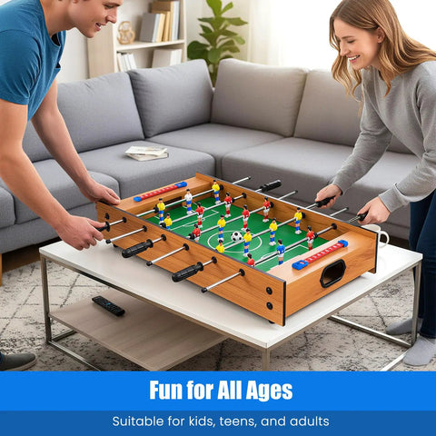 2 In 1 Swivel Mini Game Table Top Wood Foosball And Slide Hockey Combo with players in action on a living room table.