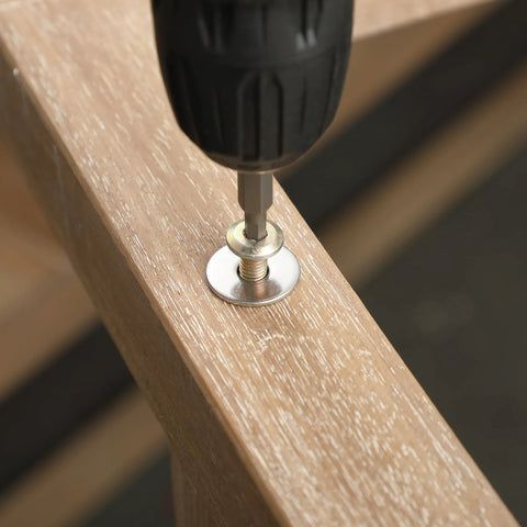 Close-up of stainless steel fender washer on wood being fastened with a power drill