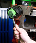 Hand using Beefy 3 Jaw Magnetic Oil Filter Wrench for Tight Spaces Heavy Duty Oil Filter Remover Fits 2.4 to 3.6 Inch Filters 3/8 Inch Drive