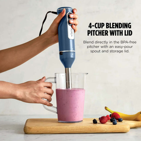 Rock Solid 9 Inch Stainless Steel Immersion Hand Blender And Rapid Whisk Set With 4 Variable Speeds blending smoothie in clear pitcher.
