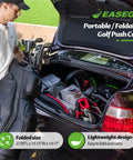 Three Wheel Golf Push Cart Quick Fold Large Platform Rolls Smooth As Butter Across Any Course Holds Drinks Phones Umbrellas Straight Up Knockout For Weekend Golfers Black with golf clubs in a car trunk.