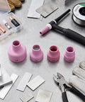 Pro Grade Ceramic Welding Cup Kit 12 14 16 24 Sizes With 2.4mm Center Hole Inner Dia For WP9 Welding Equipment arranged on table