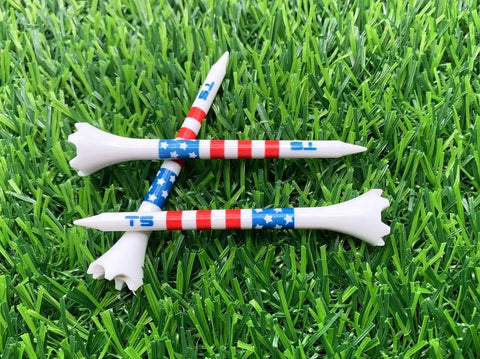 Premium USA Golf Tees In Three And A Quarter Or Two And Three Quarters Inch Durable Plastic 100 Pack Stars And Stripes Made In USA Bulk Value Pack For Longer Drives And Consistent Ball Contact shown on grass