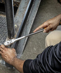 Person using Three Eighths Inch Drive 120XP Flex Head Teardrop Ratchet With Dual Material Handle Built For Tight Spaces And Heavy Duty Fastening Model 81210XP Featuring 60 Tooth Gear And Double Stacked Pawls on metal stairs.