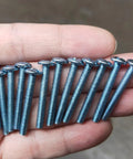 Number 8-32 X 1-1/4 Inch Truss Head Phillips Machine Screws One Pound Bulk Pack held in a hand, showcasing metal screws for DIY projects.