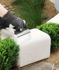 Curb Edger Trowel For Concrete Edging in use for shaping and smoothing edging block with ergonomic slant design.