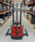 Mechmaxx 3300 Lb Electric Lithium Ion Straddle Stacker With 98 Inch Lift Height And Adjustable Legs Forks 24V Battery in warehouse aisle
