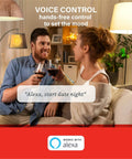 Couple using Alexa Enabled Smart Light Bulbs Four Pack with Auto Pairing for setting date night ambience in living room.