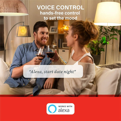 Couple using Alexa Enabled Smart Light Bulbs Four Pack with Auto Pairing for setting date night ambience in living room.