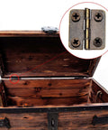 Close-up of bronze mini hinge from Two Size Bronze Mini Hinge Set With 60 Small Hinges And 300 7 Mm Screws in a wooden chest lid