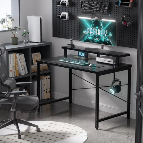 Black compact 31.5 inch computer desk with monitor stand and headphone hook in a small home office setup