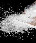 Heavy Duty Hot Melt Edgebander Glue Pellets For Cabinetry And Diy Fixes on wood surface spilling from jar.