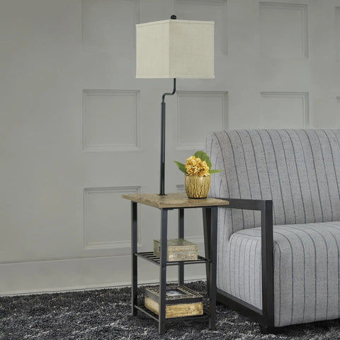Do It All Metal Floor Lamp And End Table With Built In Surface And Two Fixed Storage Shelves Industrial Casual Black Finish next to a sofa