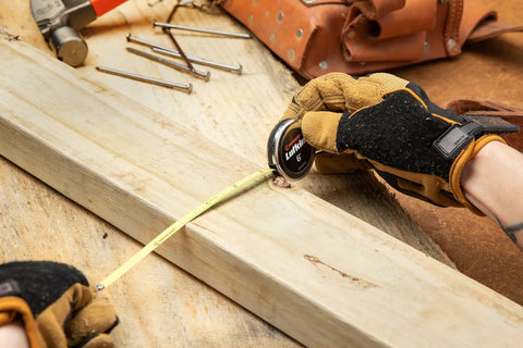 Person using Go-To Executive Diameter Yellow Clad Pocket Tape Measure with 1/4 Inch by Six Foot Blade on wood