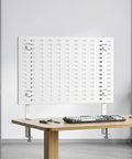 White Adjustable Iron Desk Stand Brackets Set with pegboard mounted on a wooden desk in an organized office setting