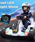 Child riding 12V Kids Electric Drift Go Kart For Ages 4 And Up With Music And LED Lights Swivel Rear Wheels Adjustable Seat Belt Outdoor Ride On Toy For Boys And Girls White Finish Safe Speed Around 4.9 MPH on track
