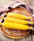 Three cobs on plate with Twin Prong Corn Cob Holders And Butter Spreader Set For Barbecue Safe Grip Stainless Steel Skewers